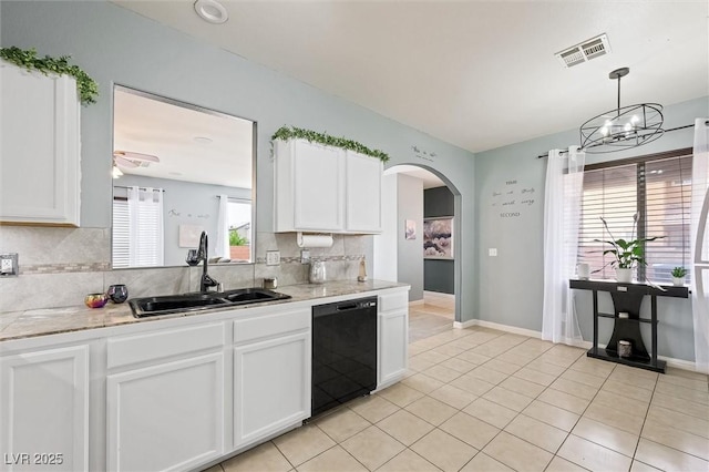 6429 Pronghorn Ridge Ave, Las Vegas, NV 89122 - kitchen featuring black dishwasher, a sink, backsplash, light countertops, and white cabinets