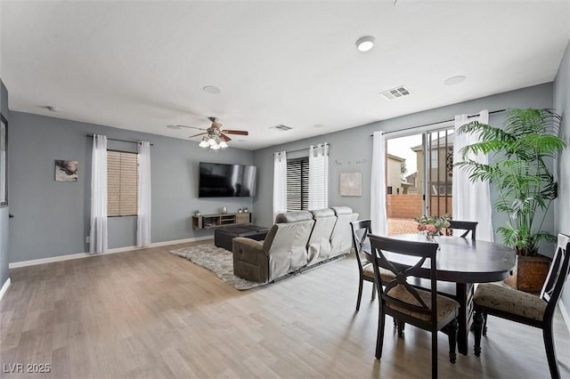 6429 Pronghorn Ridge Ave, Las Vegas, NV 89122 - dining room with wood finished floors, a ceiling fan, and baseboards
