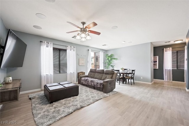 6429 Pronghorn Ridge Ave, Las Vegas, NV 89122 - living room with light wood finished floors, baseboards, and a ceiling fan