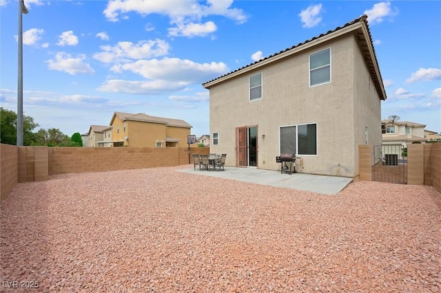 6429 Pronghorn Ridge Ave, Las Vegas, NV 89122 - rear view of house with stucco siding, a fenced backyard, and a patio area