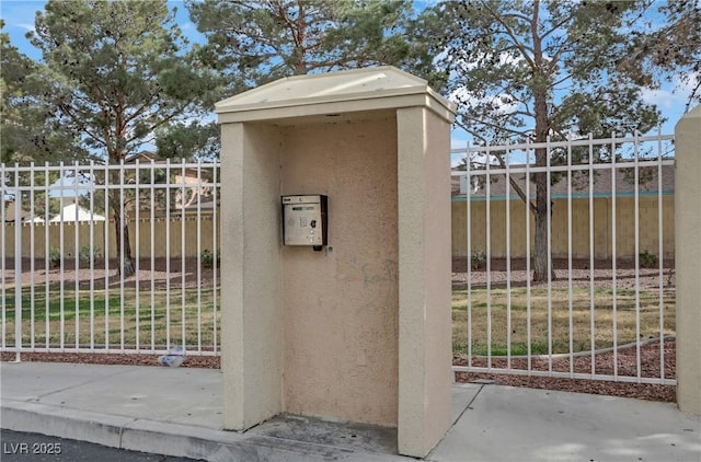 view of outdoor structure featuring a gate and fence