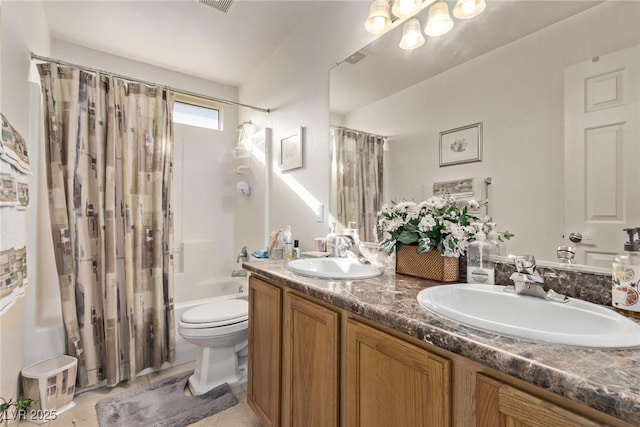 bathroom with double vanity, shower / bath combo, toilet, and a sink