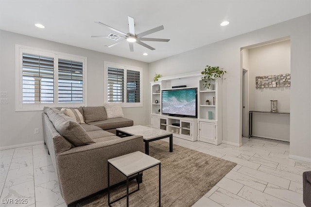 living area featuring baseboards, recessed lighting, marble finish floor, and ceiling fan