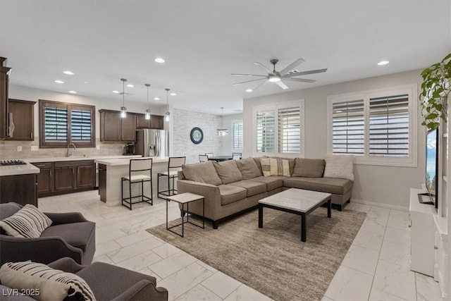 living room featuring recessed lighting, baseboards, marble finish floor, and ceiling fan