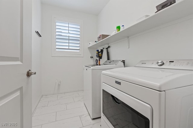 laundry area featuring washer and dryer, laundry area, baseboards, and marble finish floor