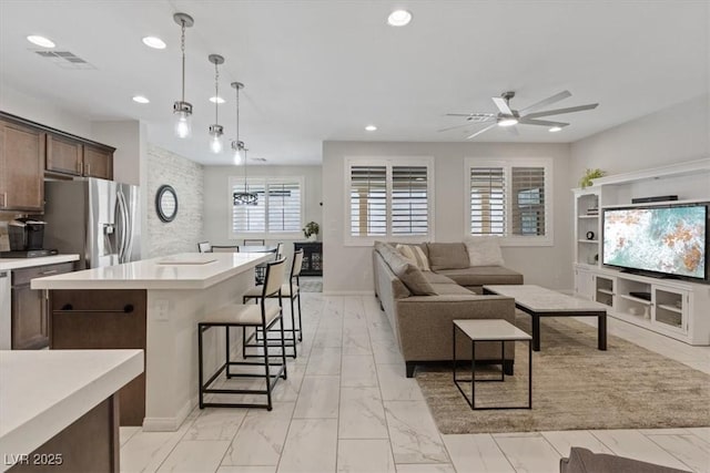 living room with visible vents, recessed lighting, marble finish floor, and a ceiling fan