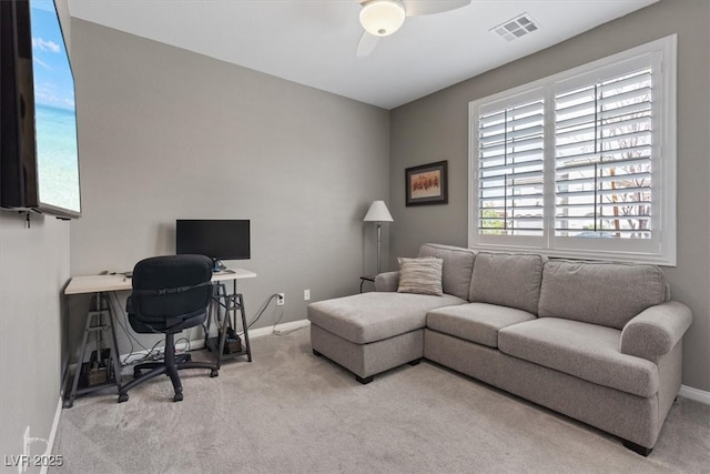 carpeted home office with visible vents, baseboards, and a ceiling fan