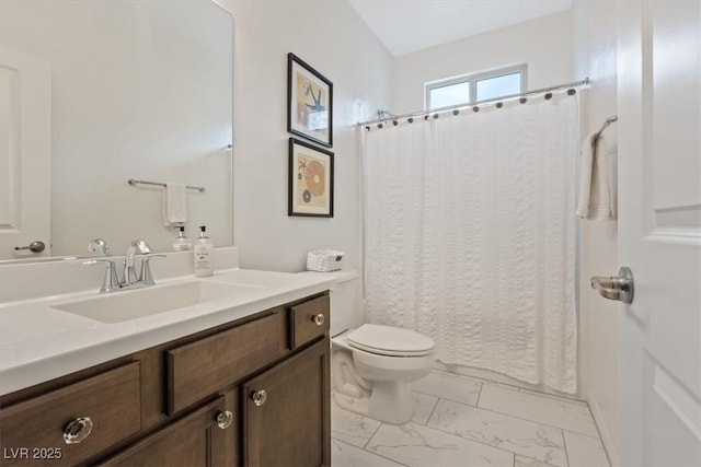 bathroom featuring marble finish floor, toilet, vanity, and a shower with curtain