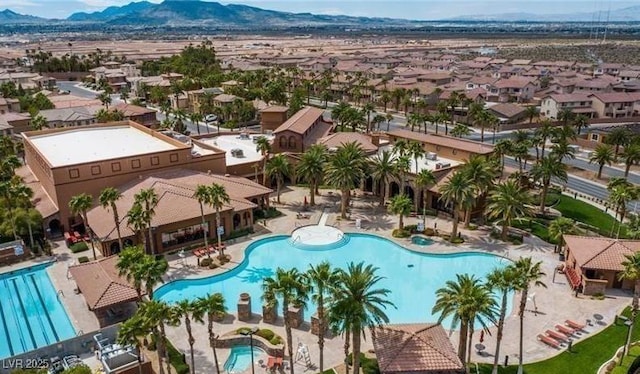 pool with a mountain view and a residential view