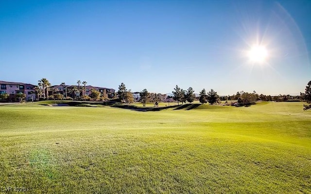 surrounding community with a residential view, a lawn, and view of golf course