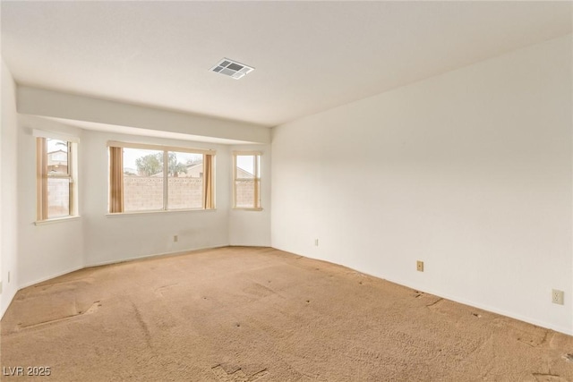 unfurnished room featuring visible vents and carpet flooring