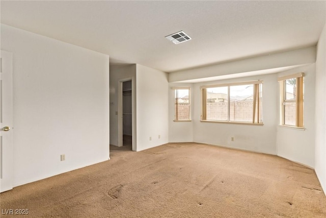 carpeted empty room with visible vents