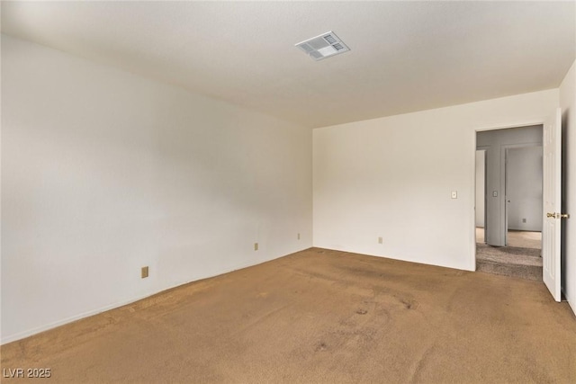 spare room with visible vents and carpet