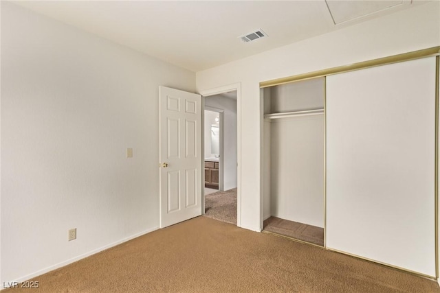 unfurnished bedroom featuring a closet, visible vents, and carpet floors