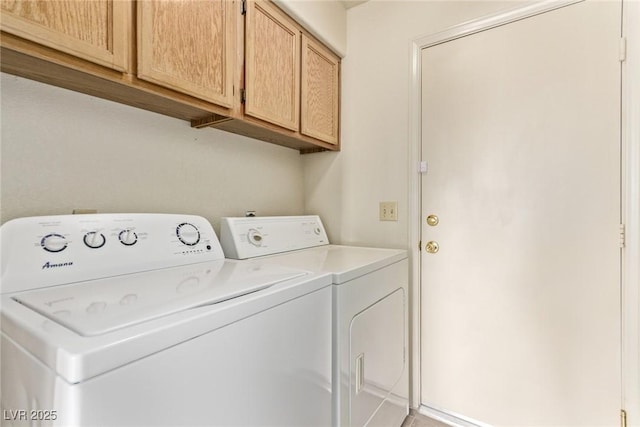 laundry room featuring cabinet space and washer and clothes dryer