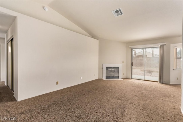 unfurnished living room featuring visible vents, carpet, a fireplace, and vaulted ceiling