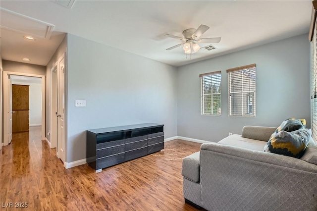 sitting room with visible vents, baseboards, wood finished floors, and a ceiling fan