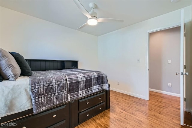 bedroom featuring light wood finished floors, a ceiling fan, and baseboards