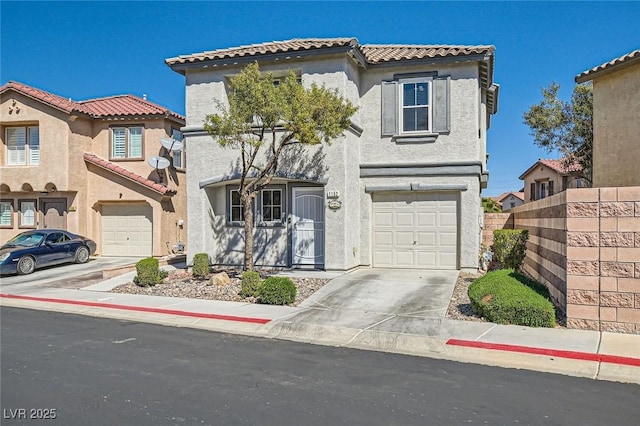 mediterranean / spanish-style house featuring stucco siding, a tiled roof, concrete driveway, and a garage