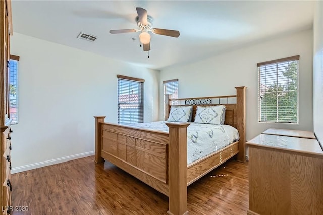 bedroom featuring multiple windows, wood finished floors, and visible vents