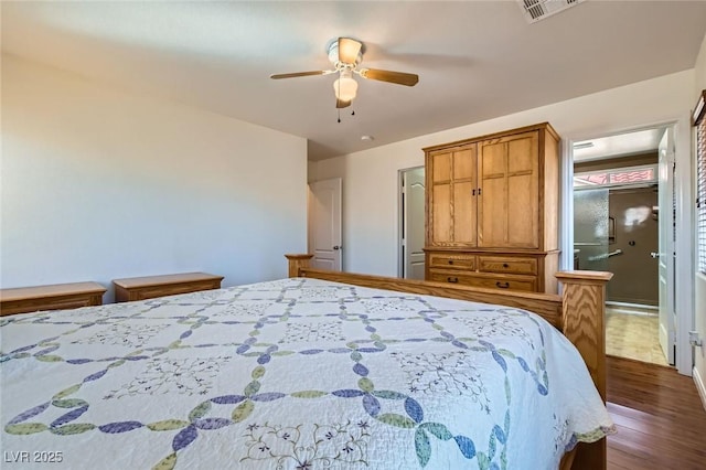 bedroom featuring visible vents, ensuite bath, ceiling fan, and dark wood-style flooring