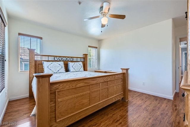 bedroom featuring a ceiling fan, baseboards, and wood finished floors