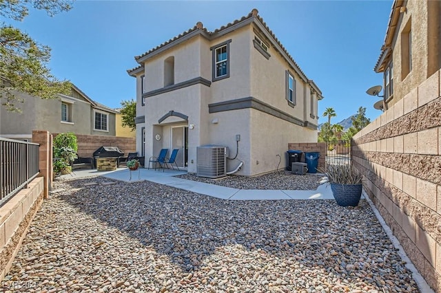 back of house featuring stucco siding, a gate, a patio, a fenced backyard, and cooling unit