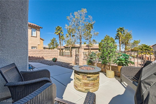 view of patio featuring fence and an outdoor fire pit