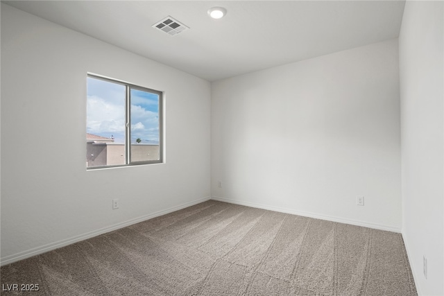 spare room with visible vents, baseboards, and carpet floors