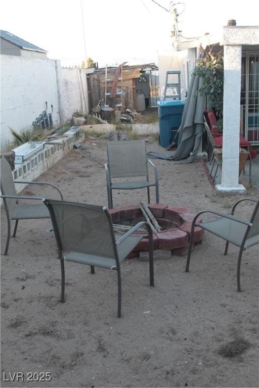 view of patio featuring fence and an outdoor fire pit