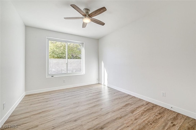 unfurnished room with baseboards, a ceiling fan, and wood finished floors