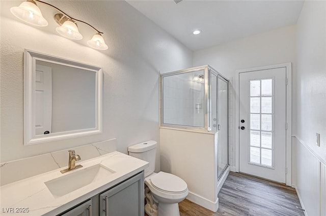 7900 Holly Knoll Ave, Las Vegas, NV 89129 - bathroom featuring wood finished floors, toilet, a stall shower, and vanity