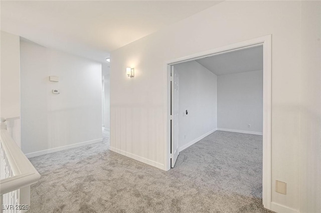 carpeted spare room with baseboards