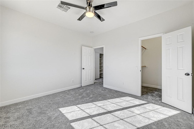 7900 Holly Knoll Ave, Las Vegas, NV 89129 - unfurnished bedroom with a spacious closet, carpet, baseboards, visible vents, and a ceiling fan