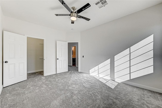 unfurnished bedroom with visible vents, ceiling fan, baseboards, and carpet