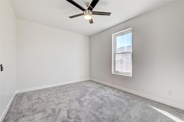 spare room with baseboards, carpet floors, and ceiling fan