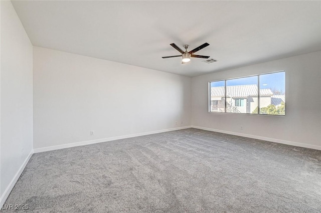 unfurnished room featuring visible vents, baseboards, a ceiling fan, and carpet floors