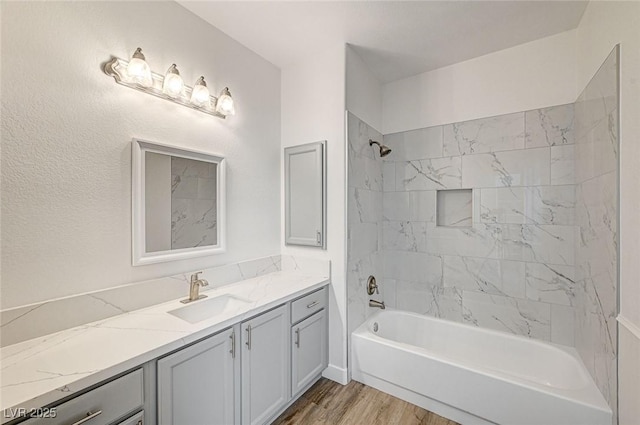 full bath featuring shower / tub combination, wood finished floors, and vanity