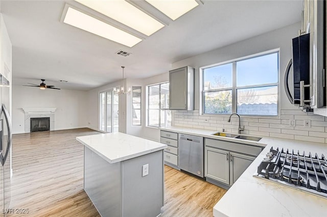 kitchen with a sink, visible vents, gray cabinets, and stainless steel appliances