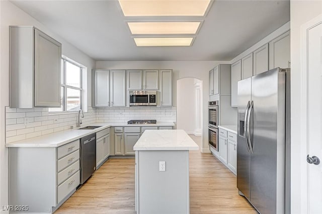 7900 Holly Knoll Ave, Las Vegas, NV 89129 - kitchen featuring gray cabinetry, a sink, appliances with stainless steel finishes, and a kitchen island