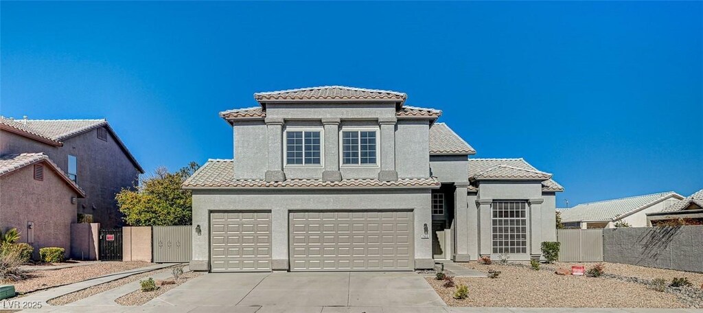 7900 Holly Knoll Ave, Las Vegas, NV 89129 - mediterranean / spanish-style house featuring an attached garage, driveway, a tiled roof, stucco siding, and fence