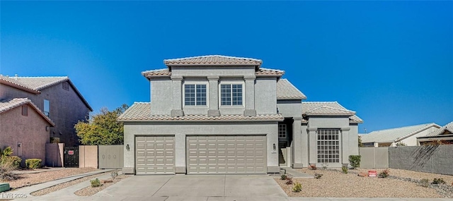 7900 Holly Knoll Ave, Las Vegas, NV 89129 - mediterranean / spanish-style house featuring an attached garage, driveway, a tiled roof, stucco siding, and fence
