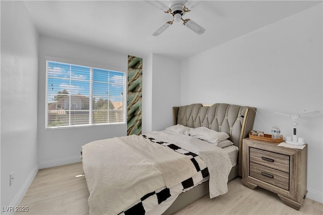 bedroom featuring baseboards, ceiling fan, and light wood finished floors