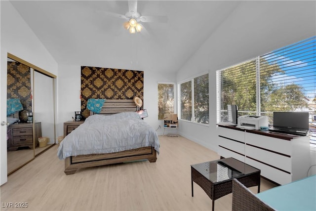 bedroom featuring a closet, lofted ceiling, and wood finished floors