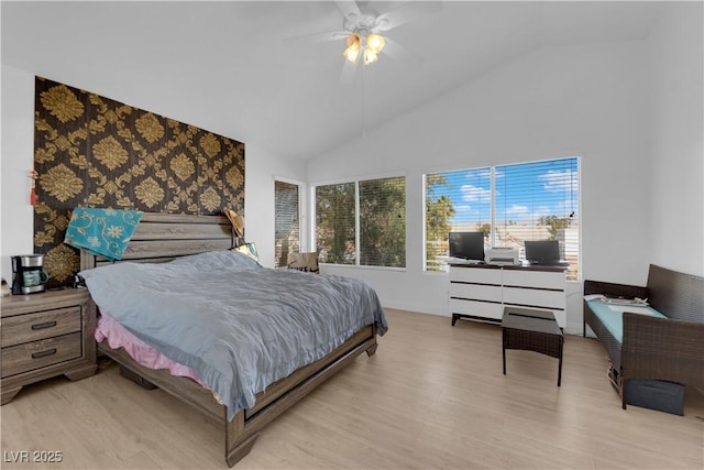 bedroom with vaulted ceiling, a ceiling fan, and wood finished floors