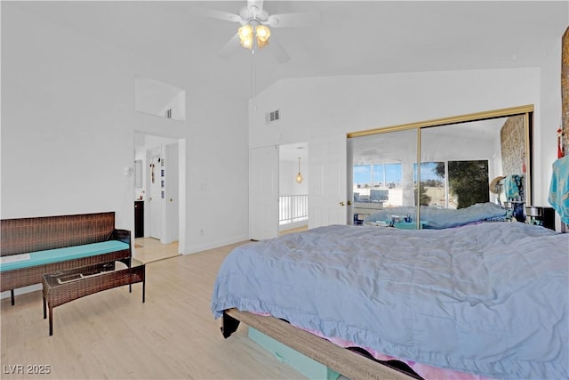 bedroom with visible vents, multiple windows, wood finished floors, and a ceiling fan