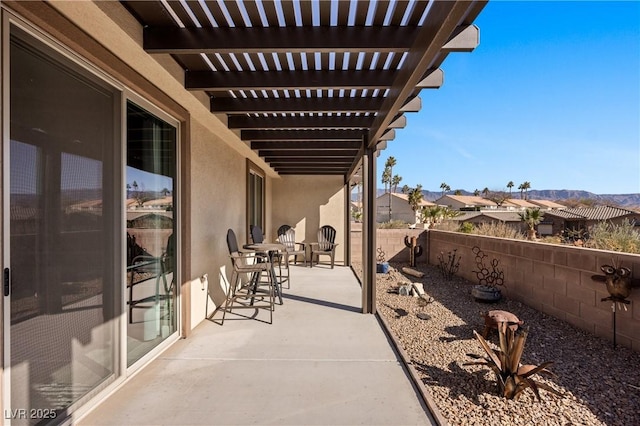 view of patio / terrace with a residential view, a pergola, and a fenced backyard