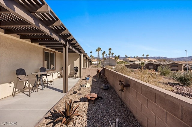 view of patio / terrace featuring a residential view, a fenced backyard, and a pergola