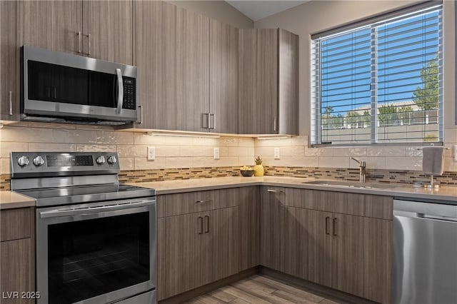 kitchen featuring appliances with stainless steel finishes, modern cabinets, and light countertops