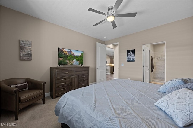 carpeted bedroom featuring connected bathroom, baseboards, and ceiling fan